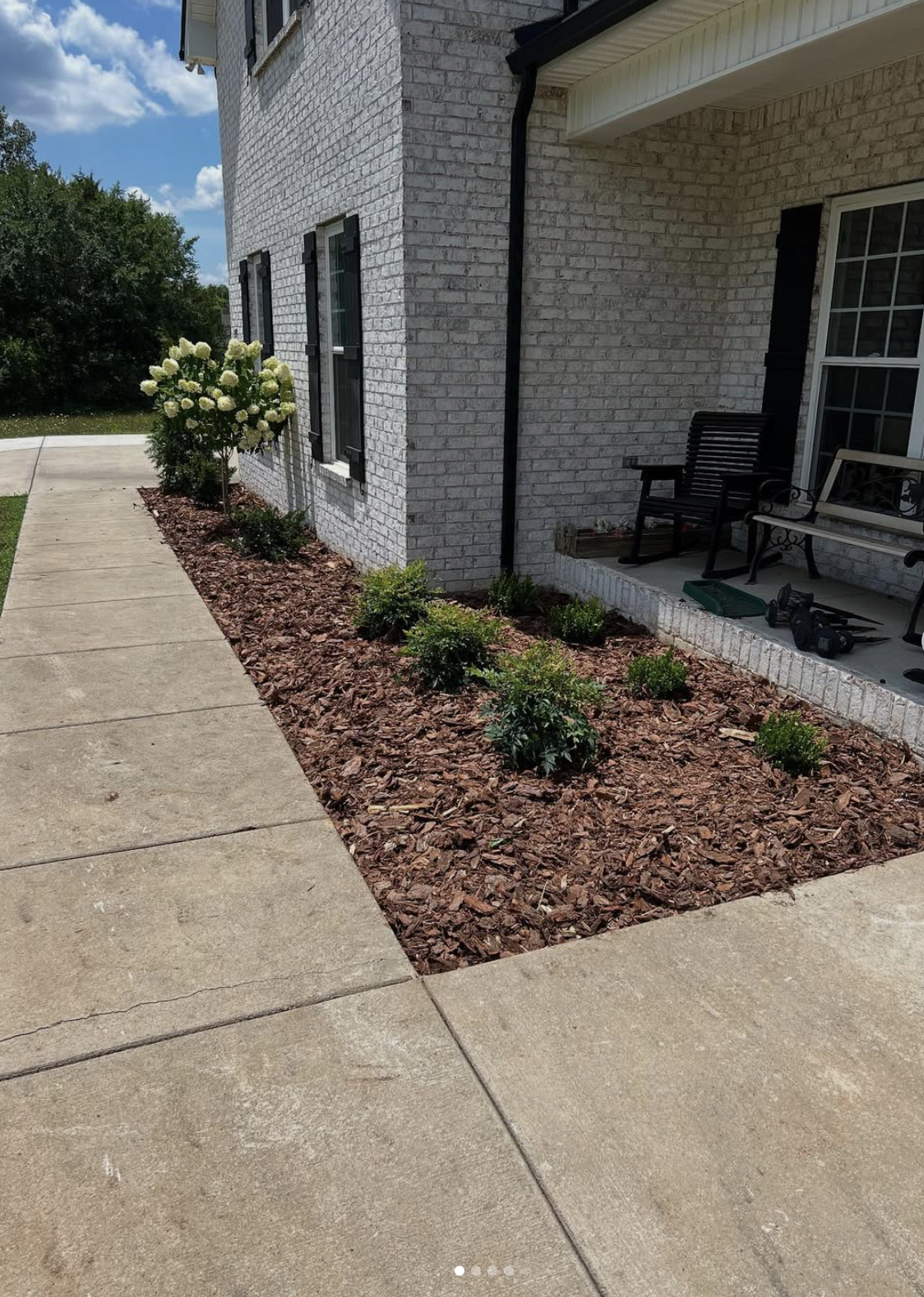 Mulch and bed lines, white brick home