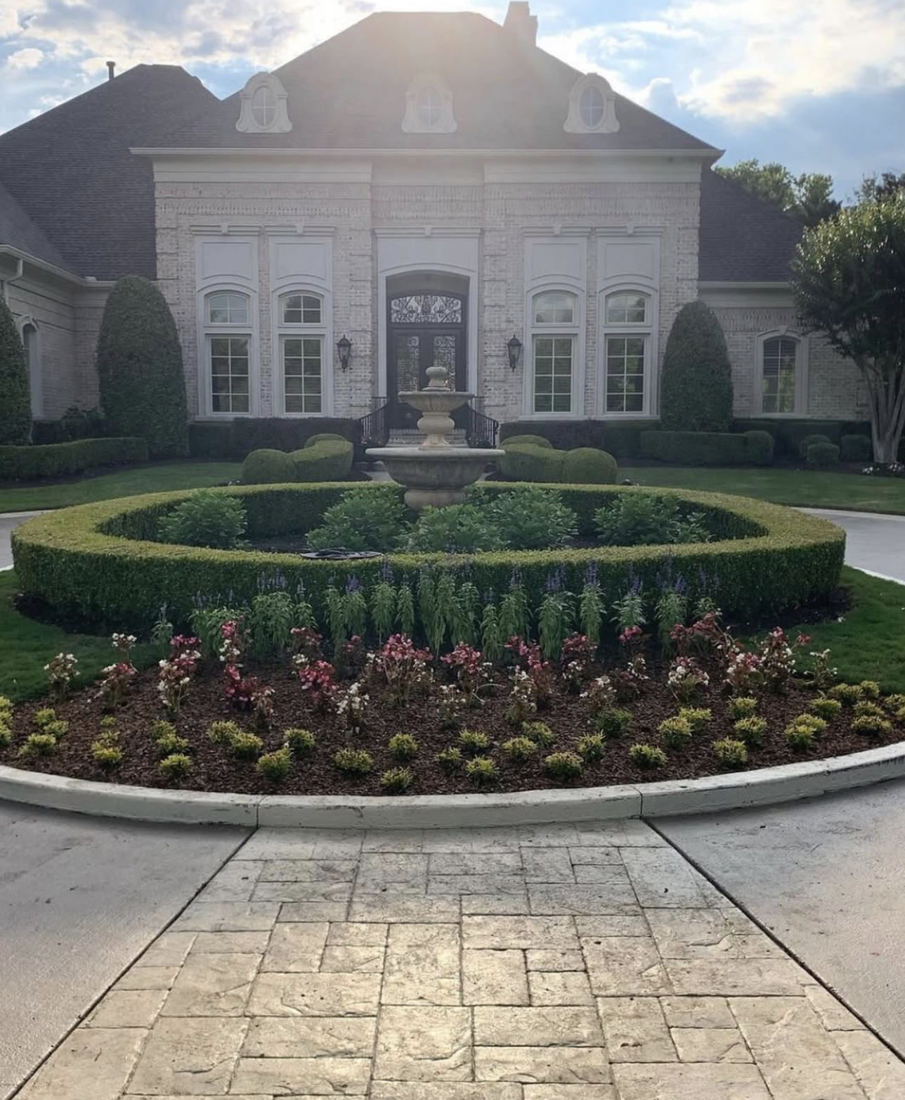 Estate front with circular fountain garden
